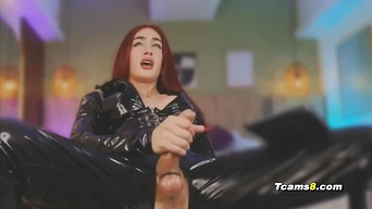 Redhead trans in latex suit jerking her hard cock
